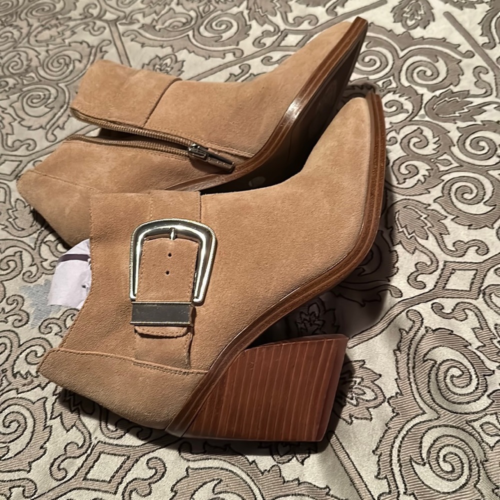 Tan buckled booties.
